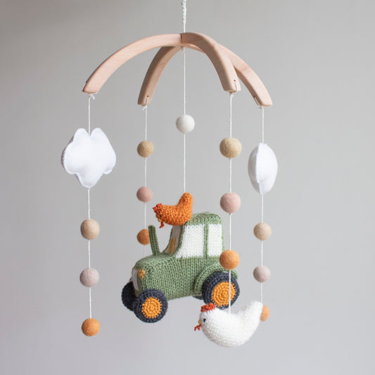 Detailed shot of three fluffy hand-knitted chickens in burnt orange and cream tones.