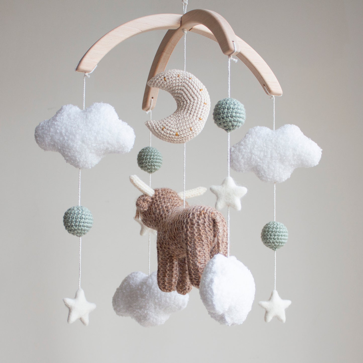 Highland cow baby mobile with boucle clouds, moon, stars in earthy neutrals with sage green accents