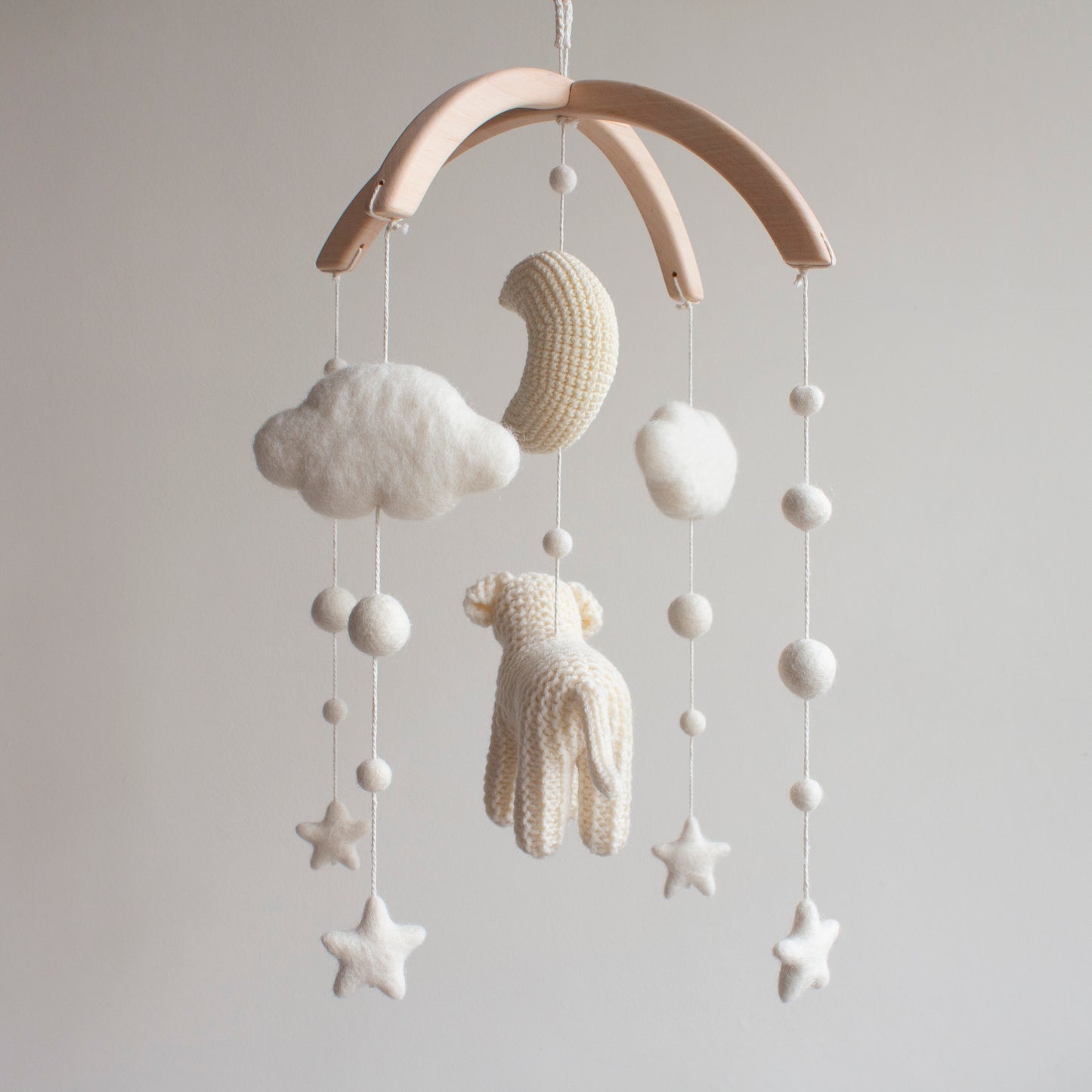 Smooth untreated solid alder wood cross-arch hanger for a minimalist artisan puppy mobile.