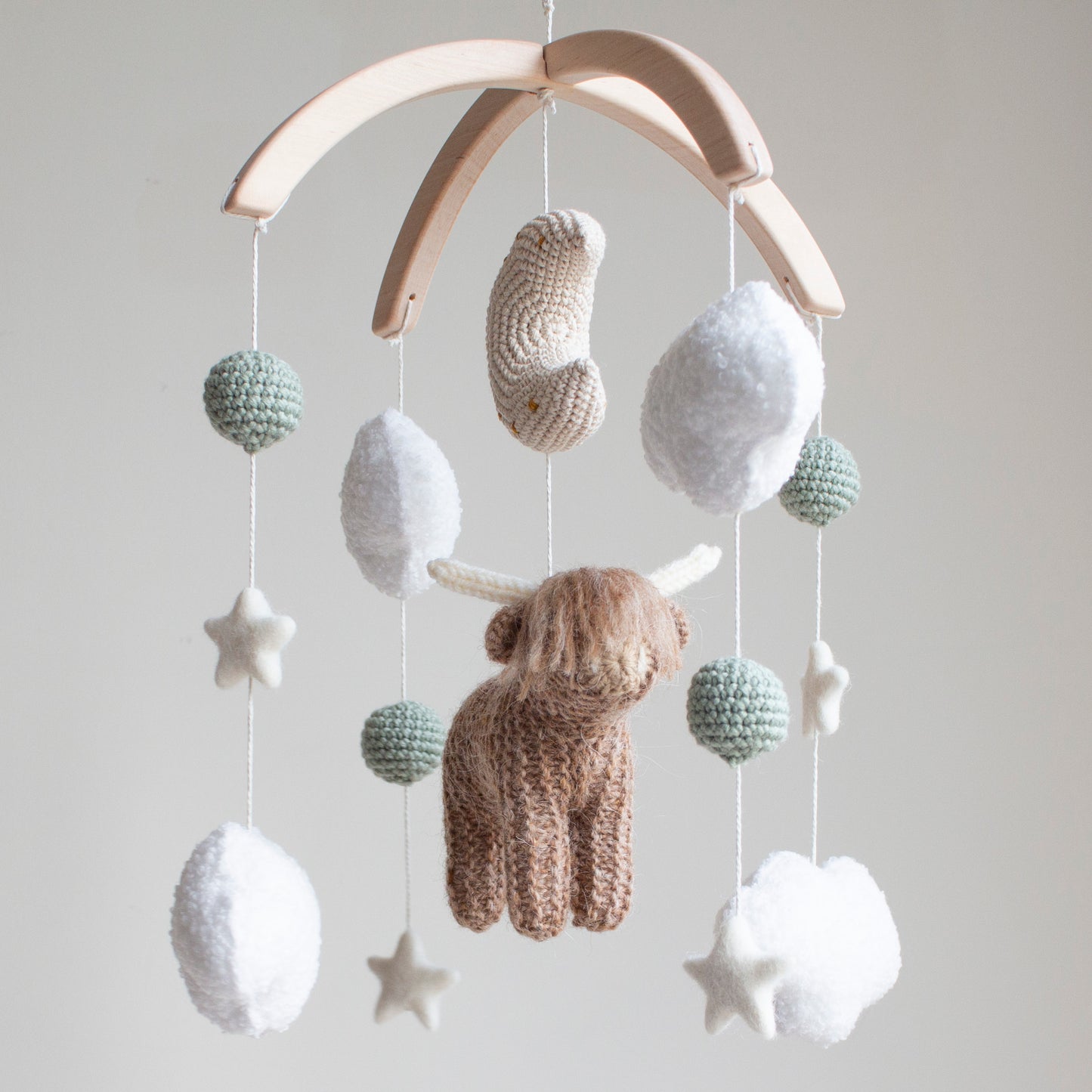 Highland cow baby mobile with boucle clouds, moon, stars in earthy neutrals with sage green accents