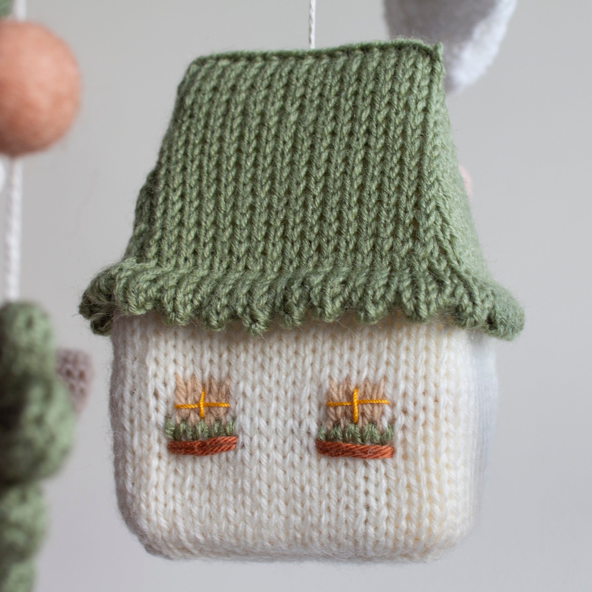 Rustic farmhouse nursery mobile perfect for hanging in a neutral-toned baby room with wooden accents.