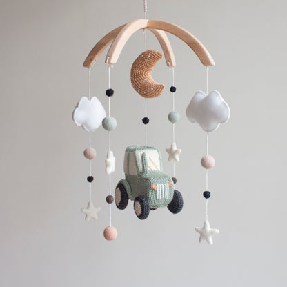 High-contrast tractor wheels and white star elements designed to support infant visual development.