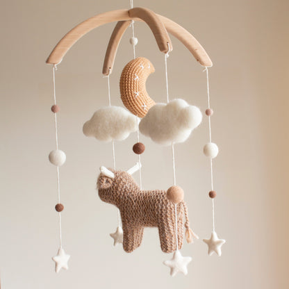 Artisan highland cow baby mobile—a unique baby shower gift for a rustic or boho nursery.