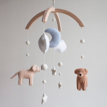 Baby mobile with knitted animals and stars on a wooden arch 