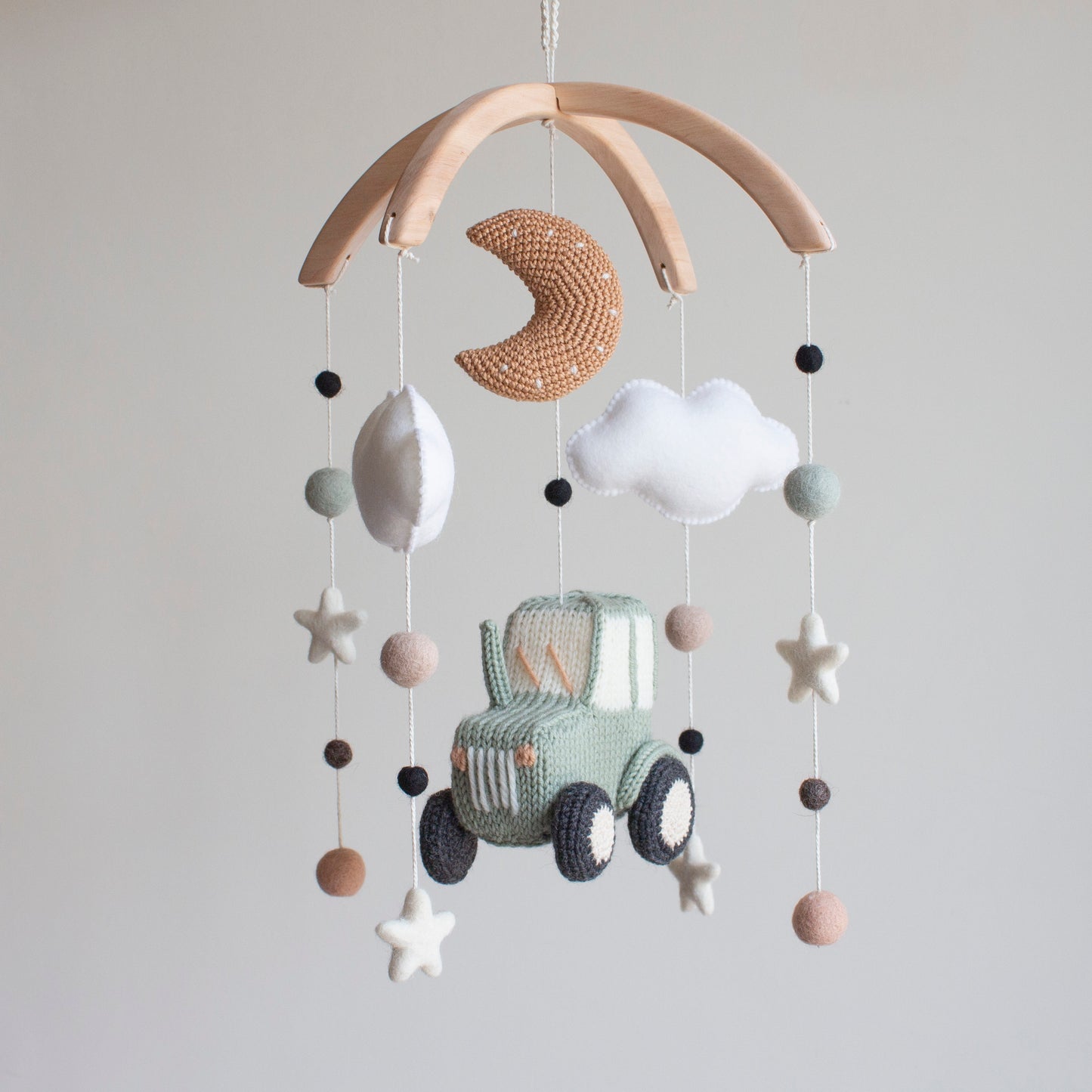 Artisan tractor baby mobile—a unique baby shower gift for vehicle-loving families and rustic nurseries.