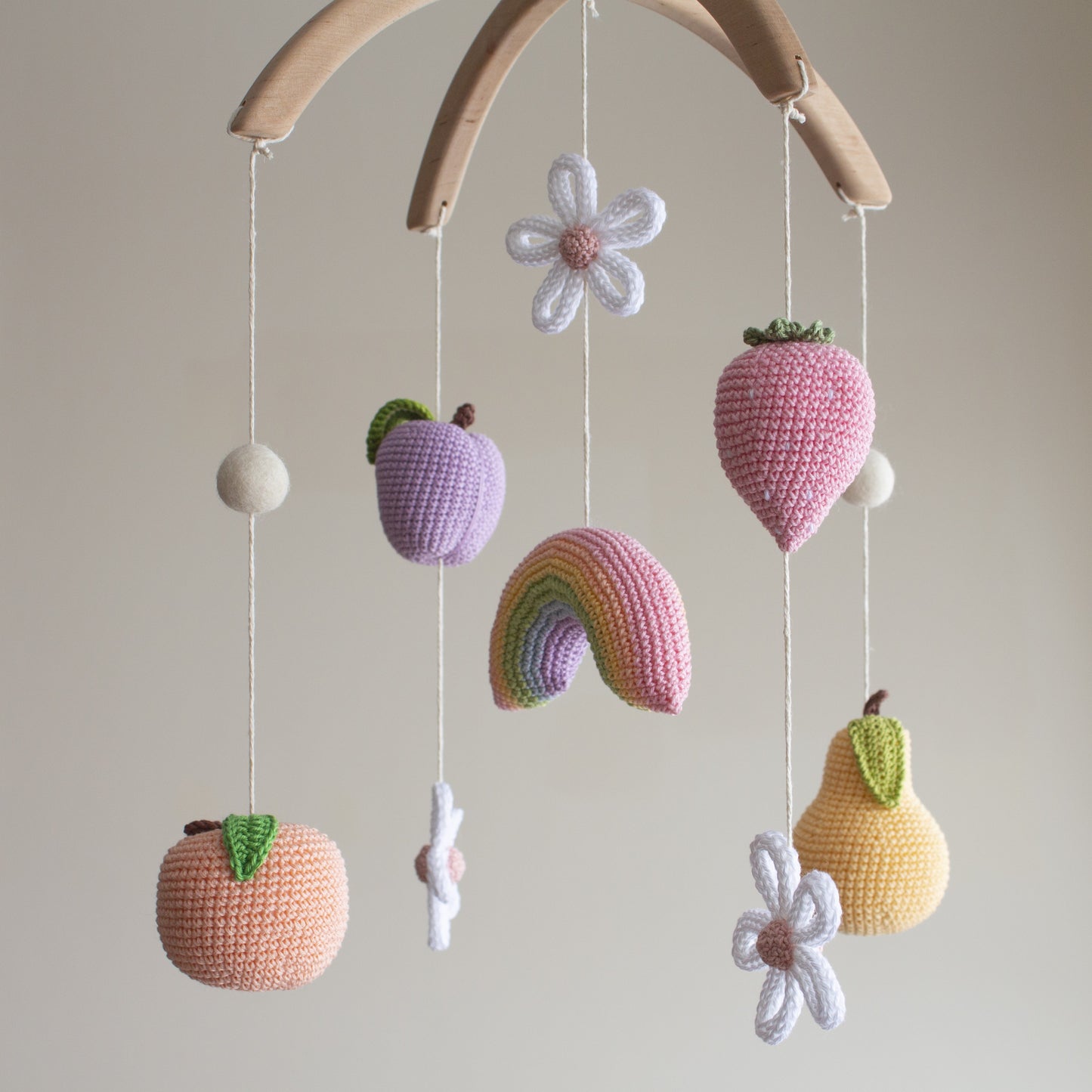 Pastel fruits with flowers and rainbow nursery mobile