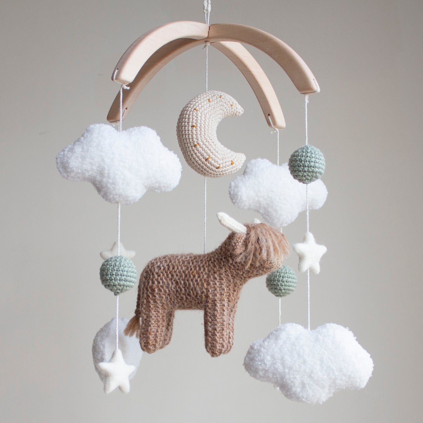 Highland cow baby mobile with boucle clouds, moon, stars in earthy neutrals with sage green accents
