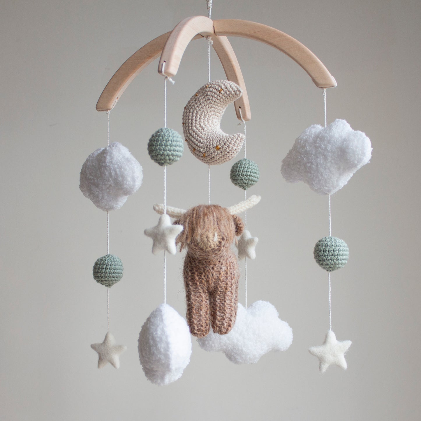 Highland cow baby mobile with boucle clouds, moon, stars in earthy neutrals with sage green accents