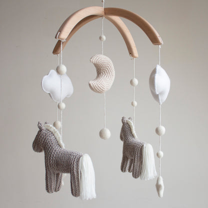 Crochet crescent moon and soft ivory stars on a horse-themed sensory mobile.
Neutral horse nursery mobile perfect for hanging in a rustic, western-themed baby room with wooden furniture.