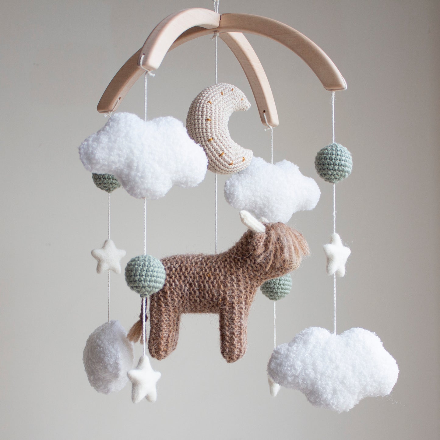 Highland cow baby mobile with boucle clouds, moon, stars in earthy neutrals with sage green accents