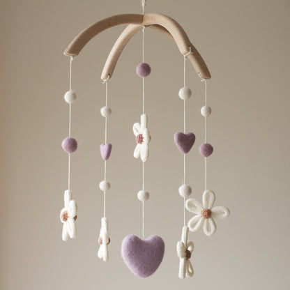 Untreated solid alder wood cross-arch hanger for a minimalist artisan baby mobile. Artisan daisy nursery mobile—a unique baby shower gift for a boho girl nursery.