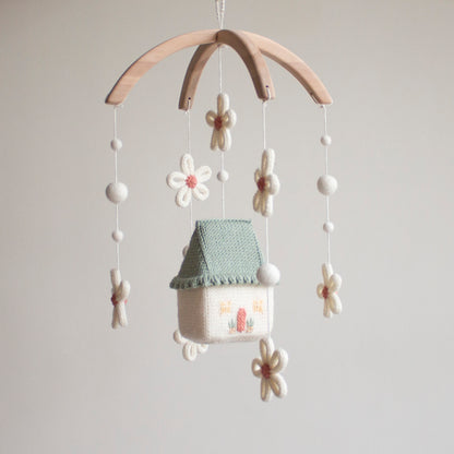 Smooth, untreated solid alder wood arch hanger for a minimalist artisan baby mobile. Daisy cottage nursery mobile showing high-contrast white and green elements for infant visual stimulation.