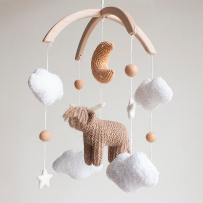 Highland cow baby mobile with boucle clouds, moon in earthy browns