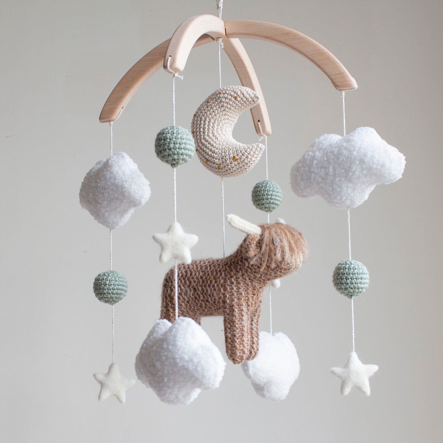 Highland cow baby mobile with boucle clouds, moon, stars in earthy neutrals with sage green accents