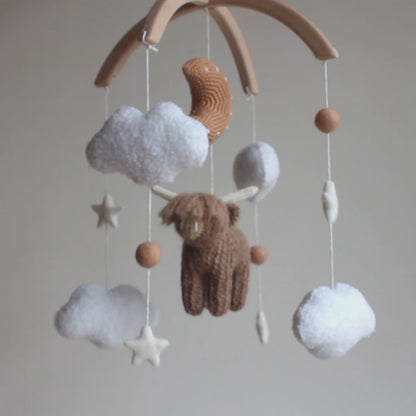 Highland cow baby mobile with boucle clouds, moon in earthy browns
